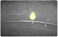 Жовта маркування на шині (кругла або трикутна мітка) на боковині означає найлегше місце на шині